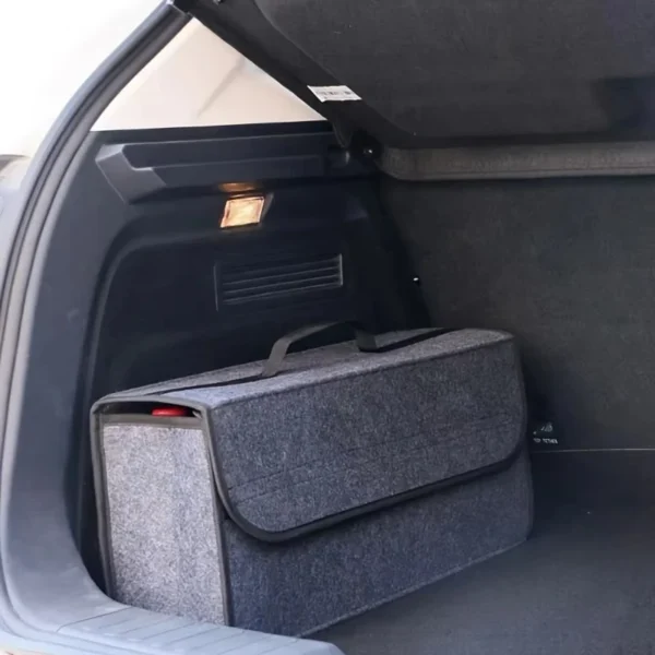Foldable felt trunk box open in a car trunk holding groceries and camping gear