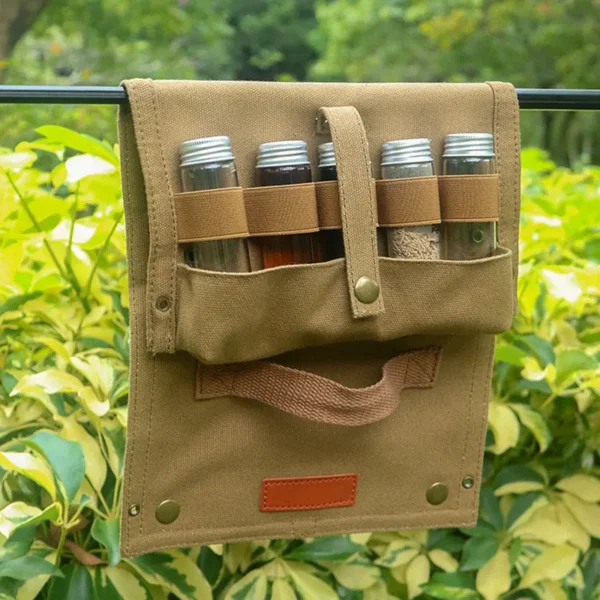 Khaki canvas spice bottle storage bag open with ten seasoning bottles hanging from a tree
