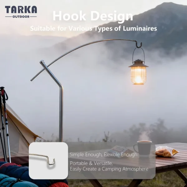 Detachable lantern stand in black aluminum on a camp table with a lantern hanging from the arm