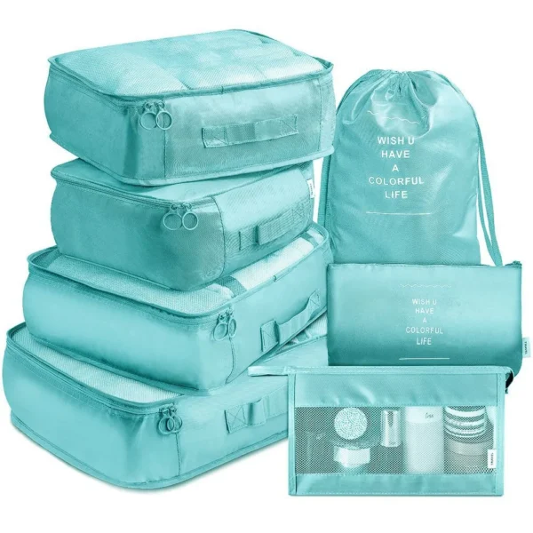 Folding wardrobe packing cubes in navy, seven bags including a shoe bag beside a suitcase