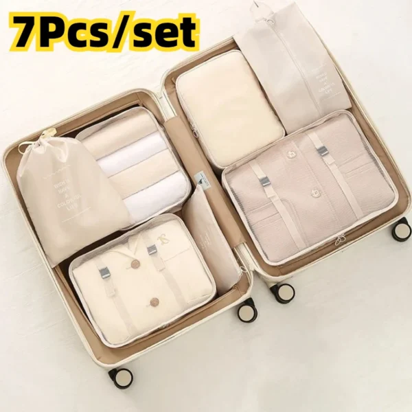 Grey travel packing organizer set of seven bags packed with clothes and shoes