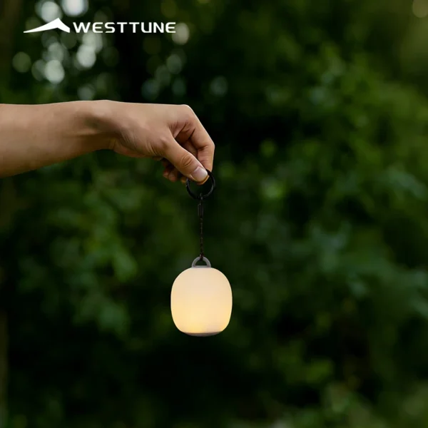 WESTTUNE mini camping lantern set of four small LED lamps glowing on a picnic table