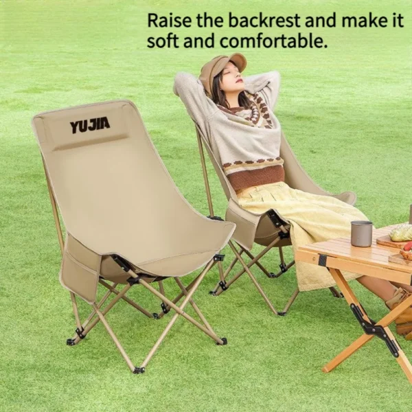 Carbon steel moon chair with high back orange fabric seat unfolded on a grassy campsite