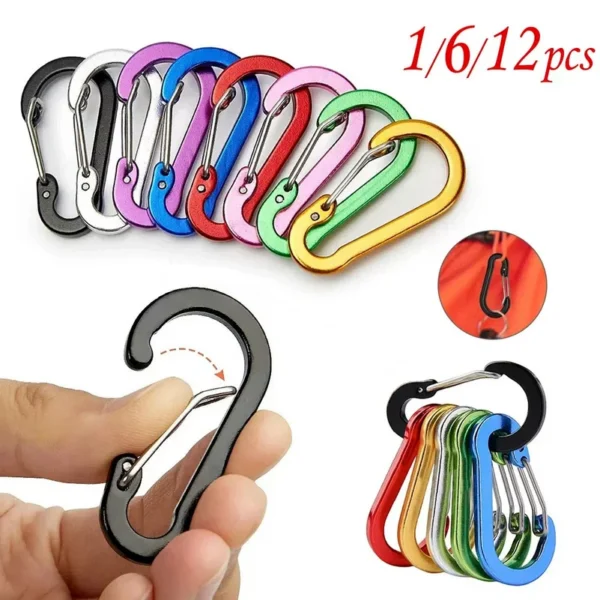 Mini carabiner keychain clips in mixed colors with aluminum spring gates on a backpack