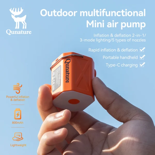 Electric camping air pump with light on inflating an air mattress inside a tent at night