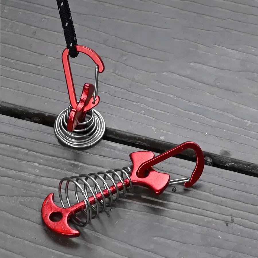 Fish Bone Tent Pegs 5 Pack Stainless Steel with Rope Buckles 1 Five fish bone tent pegs in stainless steel with rope buckles fixed to a wooden camping deck