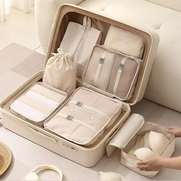 8 piece luggage organizers in navy with mesh tops, holding clothes, shoes and cables