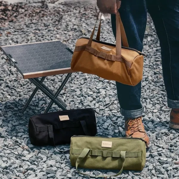 Green zippered tent stake pouch with carry handle holding tent pegs, guy rope and a camping hammer