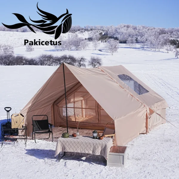 Inflatable glamping tent in khaki with roof set up beside a car at a campsite